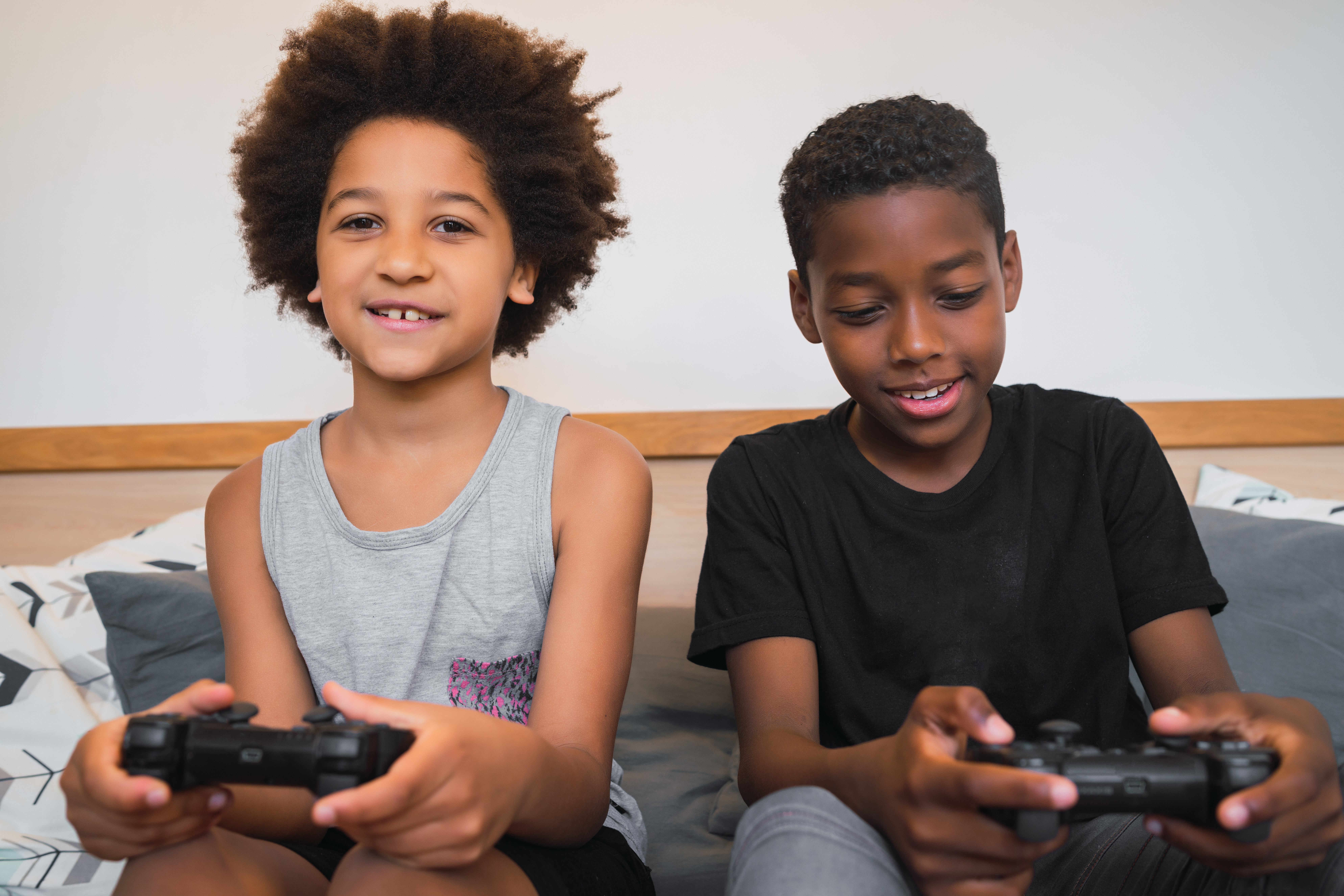 Two brothers playing video games at home.
