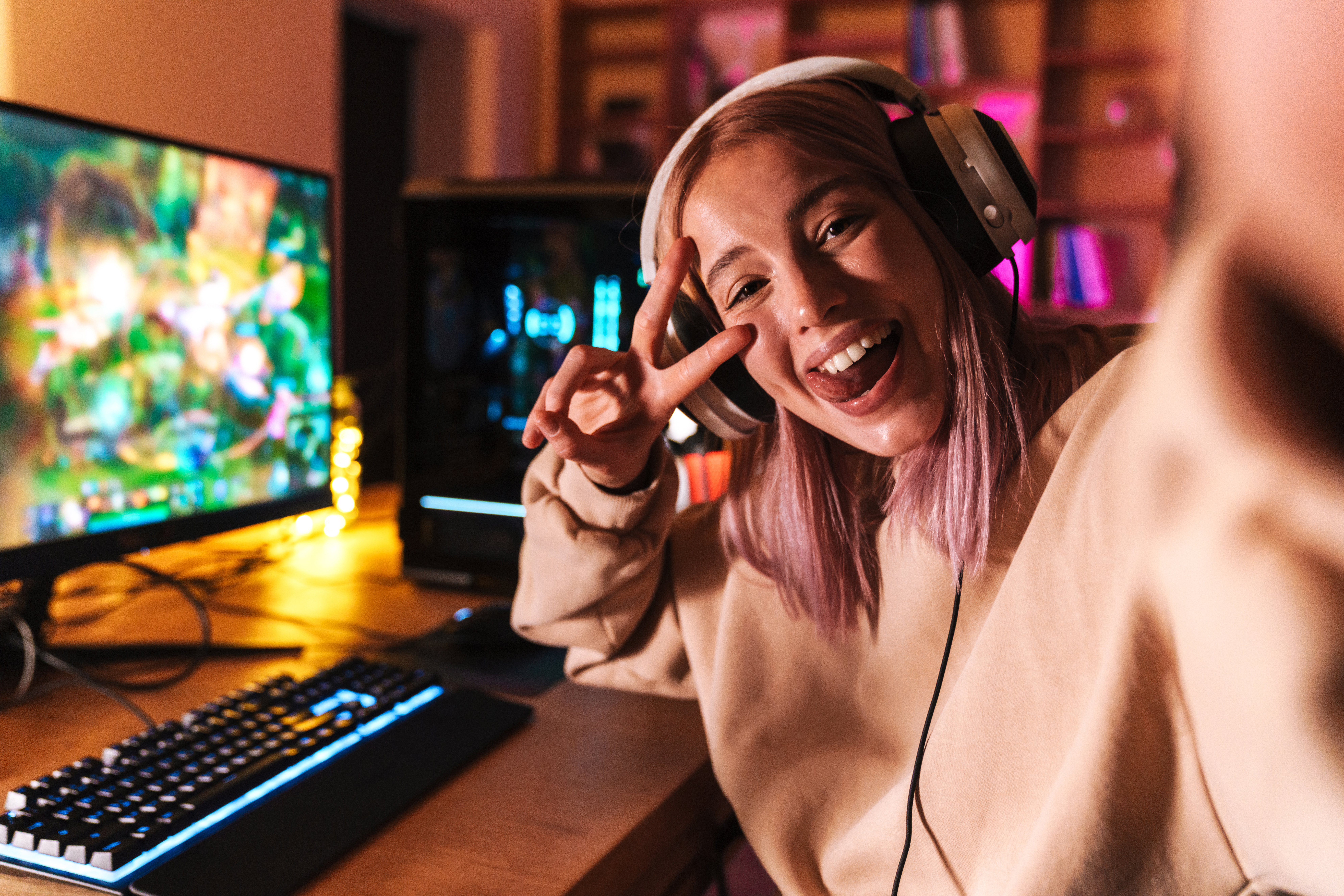 Image of excited girl taking selfie photo while playing video ga